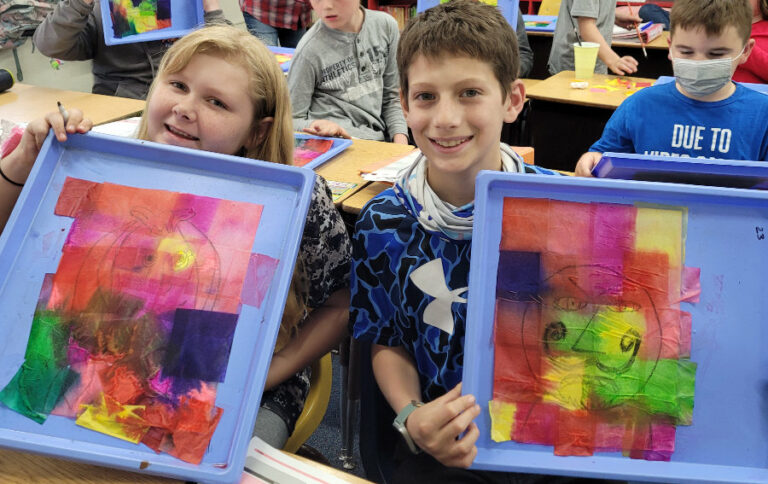 elementary school kids with art projects