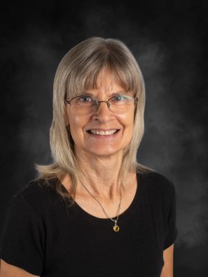 Mrs. Laurel Ferretti, smiling woman with blonde hair, glasses, and a black shirt.