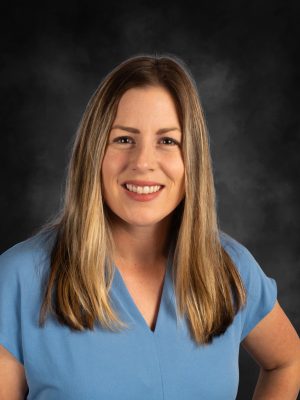 Mrs. Angie Fackrell portrait, smiling with light brown hair and wearing a blue top.