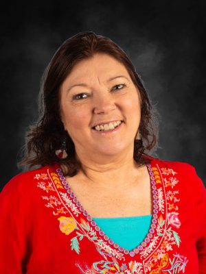 Mrs. Tammy Alvidrez smiling in a red embroidered top.